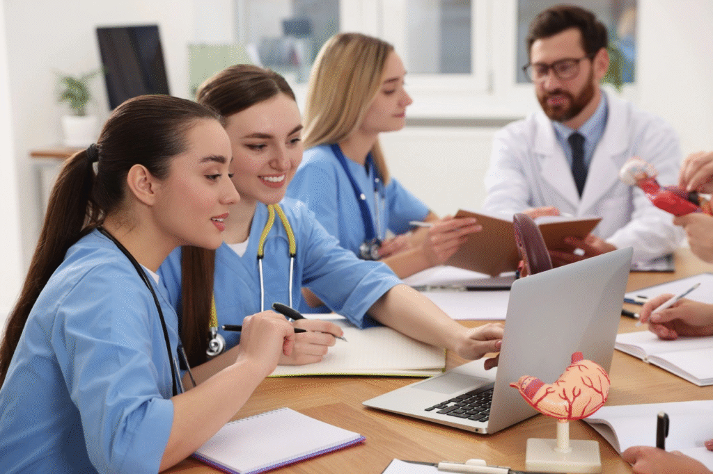 Medical team collaborating around a laptop.